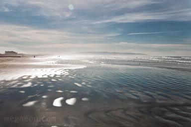 beach of water reflecting blue sky